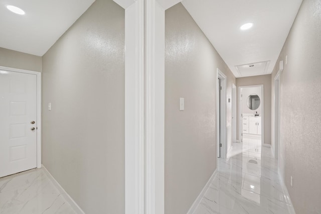 2414 Camillia St, Highlands, TX 77562 - hall with light marble finish flooring, baseboards, attic access, and a textured wall