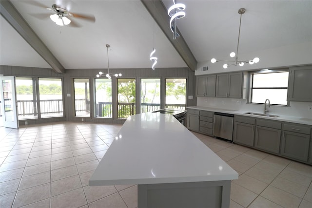 110 Bayou Dr, Baytown, TX 77520 - kitchen with stainless steel dishwasher, gray cabinets, light tile patterned floors, a sink, and light countertops