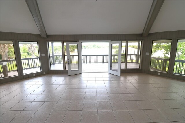 110 Bayou Dr, Baytown, TX 77520 - unfurnished sunroom featuring tile patterned floors, french doors, plenty of natural light, and wooden walls