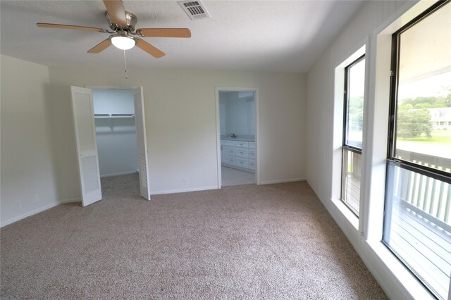 110 Bayou Dr, Baytown, TX 77520 - unfurnished bedroom featuring carpet flooring, connected bathroom, baseboards, and a ceiling fan
