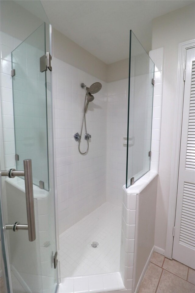 110 Bayou Dr, Baytown, TX 77520 - full bath featuring tile patterned floors, a shower stall, and baseboards