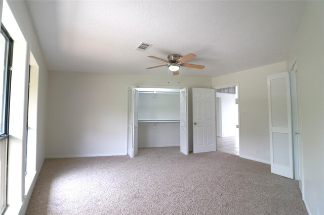 110 Bayou Dr, Baytown, TX 77520 - unfurnished bedroom with carpet floors, a closet, baseboards, ceiling fan, and a textured ceiling