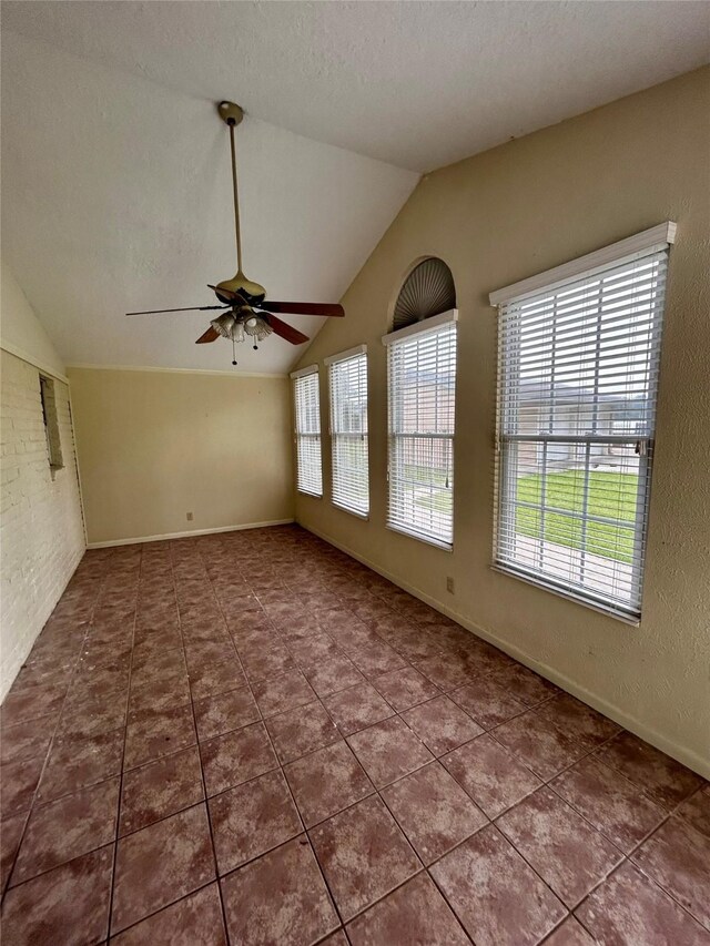125 Mimosa Pt, Livingston, TX 77351 - tiled empty room featuring lofted ceiling, a ceiling fan, a textured ceiling, and baseboards