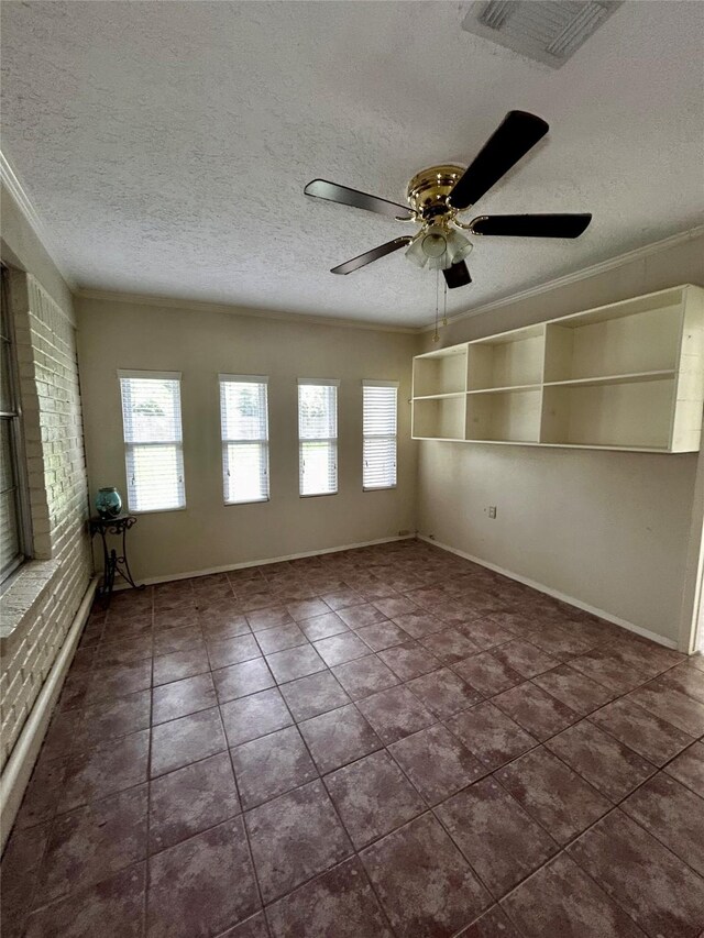 125 Mimosa Pt, Livingston, TX 77351 - spare room featuring plenty of natural light, a textured ceiling, crown molding, dark tile patterned flooring, and ceiling fan