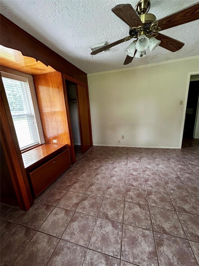 125 Mimosa Pt, Livingston, TX 77351 - unfurnished bedroom with a textured ceiling, crown molding, tile patterned flooring, a closet, and a ceiling fan