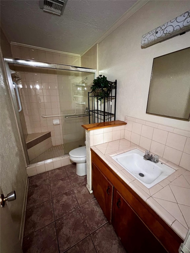 125 Mimosa Pt, Livingston, TX 77351 - bathroom with ornamental molding, toilet, a stall shower, vanity, and a textured ceiling