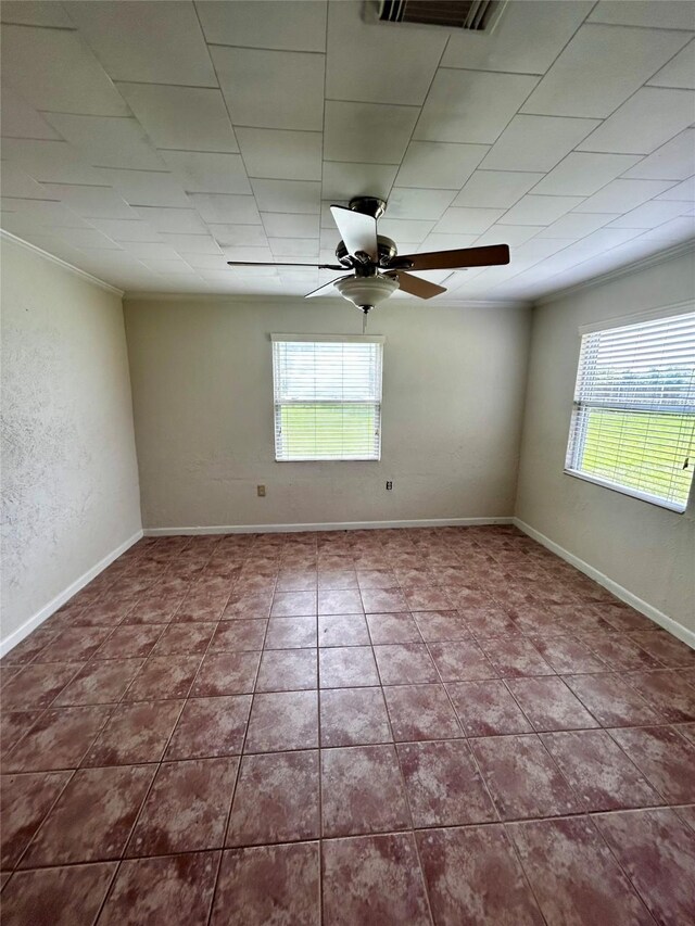 125 Mimosa Pt, Livingston, TX 77351 - spare room featuring healthy amount of natural light, crown molding, a ceiling fan, tile patterned flooring, and baseboards