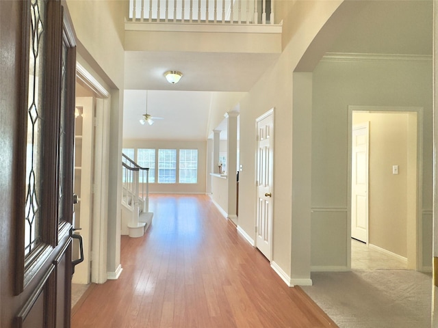 2807 Enchanted Landing Ct, Katy, TX 77494 - entrance foyer featuring stairway, baseboards, light wood-style floors, a ceiling fan, and a high ceiling
