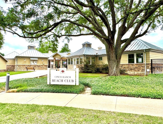 2807 Enchanted Landing Ct, Katy, TX 77494 - view of front of house with stone siding, a standing seam roof, and a front yard