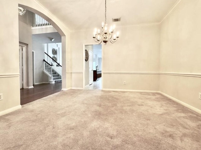 2807 Enchanted Landing Ct, Katy, TX 77494 - unfurnished dining area featuring carpet floors, a chandelier, arched walkways, stairs, and crown molding