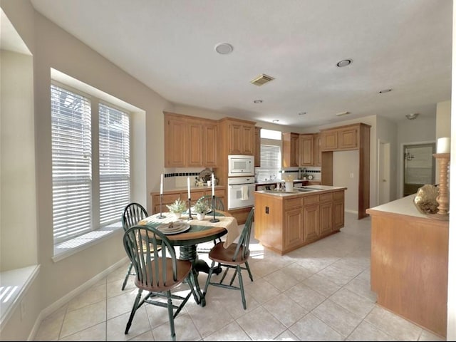 2807 Enchanted Landing Ct, Katy, TX 77494 - dining room with plenty of natural light, light tile patterned floors, and baseboards