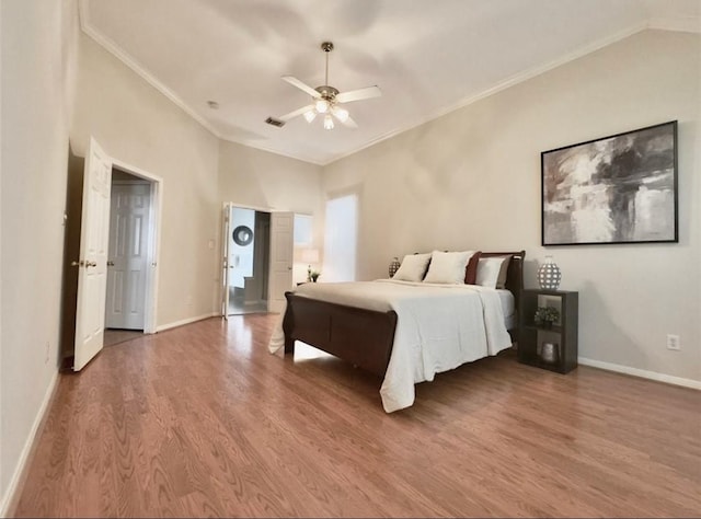 2807 Enchanted Landing Ct, Katy, TX 77494 - bedroom featuring wood finished floors, crown molding, baseboards, lofted ceiling, and a ceiling fan