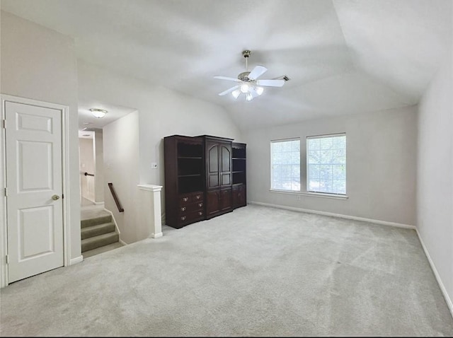 2807 Enchanted Landing Ct, Katy, TX 77494 - unfurnished living room featuring a ceiling fan, carpet, lofted ceiling, baseboards, and stairway