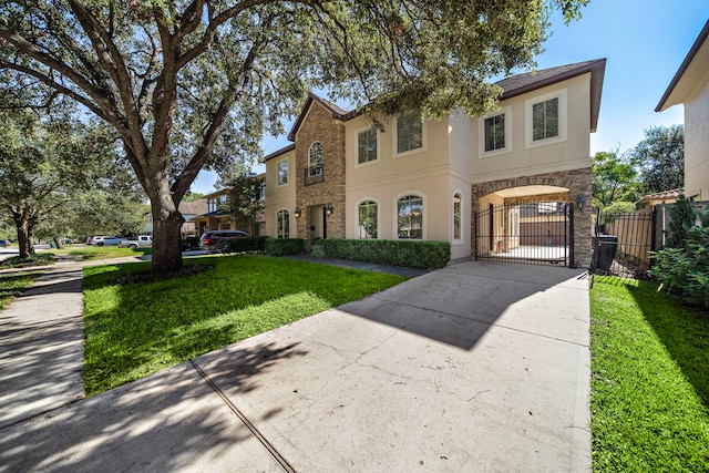 3327 Elmridge St, Houston, TX 77025 - view of front of property with stone siding, a gate, driveway, stucco siding, and a garage