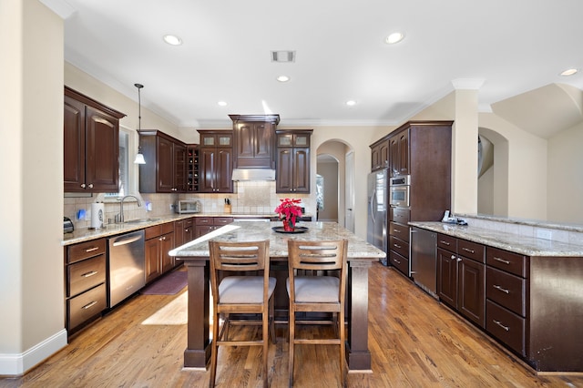 3327 Elmridge St, Houston, TX 77025 - kitchen featuring stainless steel appliances, arched walkways, a sink, ornamental molding, and dark brown cabinetry