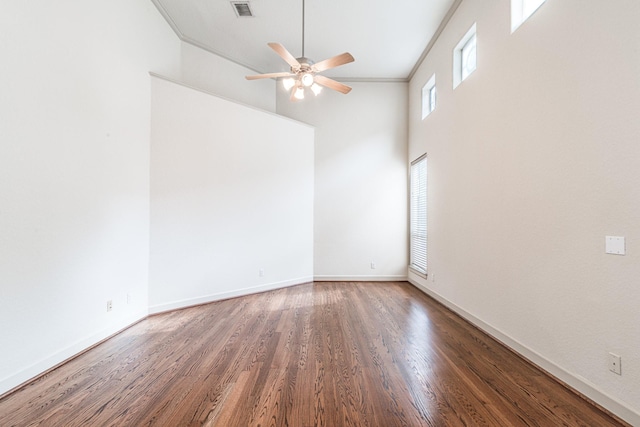 403 Harborside Way, Kemah, TX 77565 - unfurnished room with ceiling fan, wood finished floors, crown molding, baseboards, and a high ceiling