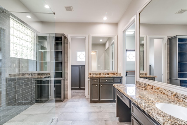 403 Harborside Way, Kemah, TX 77565 - bathroom with two vanities, a shower, and recessed lighting