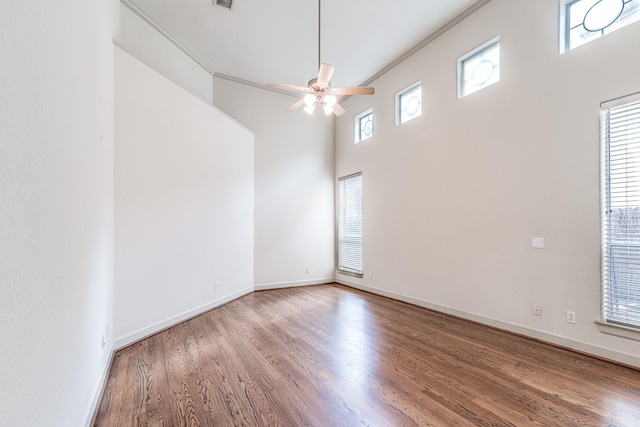 403 Harborside Way, Kemah, TX 77565 - empty room with wood finished floors, a ceiling fan, baseboards, and a high ceiling