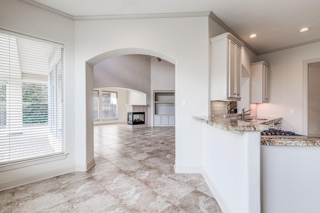 403 Harborside Way, Kemah, TX 77565 - kitchen with light stone countertops, a sink, baseboards, ornamental molding, and recessed lighting