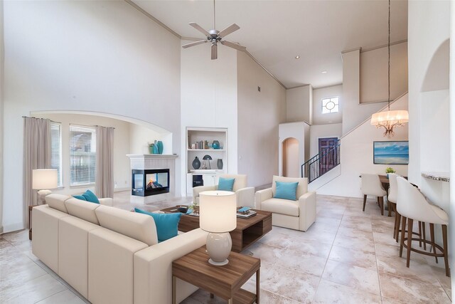 403 Harborside Way, Kemah, TX 77565 - living area featuring high vaulted ceiling, a chandelier, built in shelves, a multi sided fireplace, and healthy amount of natural light
