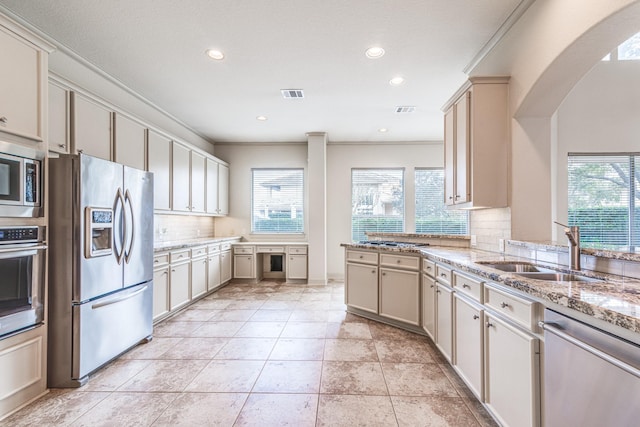 403 Harborside Way, Kemah, TX 77565 - kitchen with stainless steel appliances, a sink, decorative backsplash, arched walkways, and recessed lighting