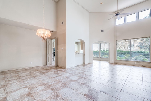 403 Harborside Way, Kemah, TX 77565 - unfurnished living room featuring ceiling fan, a chandelier, healthy amount of natural light, a high ceiling, and baseboards