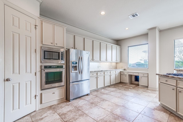 403 Harborside Way, Kemah, TX 77565 - kitchen with stainless steel appliances, crown molding, recessed lighting, backsplash, and light tile patterned floors