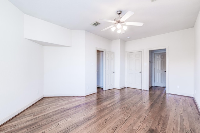 403 Harborside Way, Kemah, TX 77565 - unfurnished bedroom featuring wood finished floors, baseboards, and a ceiling fan