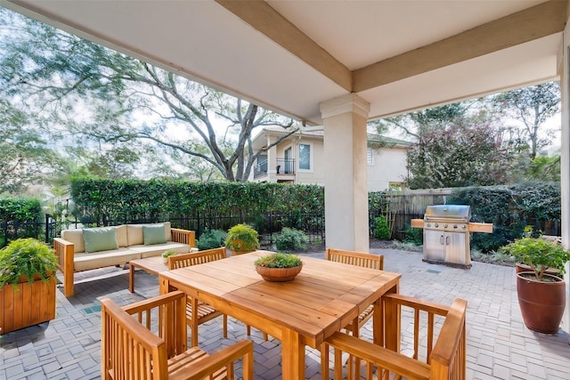 403 Harborside Way, Kemah, TX 77565 - fenced backyard featuring a patio, outdoor lounge area, a grill, and outdoor dining space