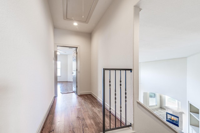 403 Harborside Way, Kemah, TX 77565 - hall with attic access, healthy amount of natural light, wood finished floors, recessed lighting, and baseboards