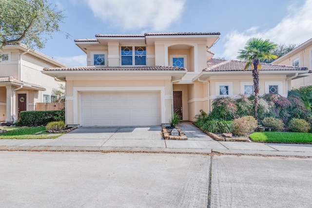 403 Harborside Way, Kemah, TX 77565 - mediterranean / spanish home with a tile roof, concrete driveway, a garage, and stucco siding