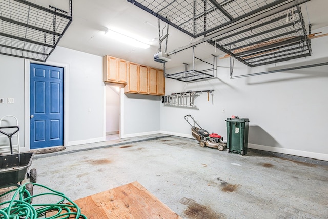 403 Harborside Way, Kemah, TX 77565 - garage featuring baseboards and a garage door opener