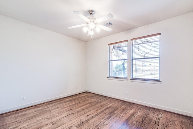 403 Harborside Way, Kemah, TX 77565 - unfurnished room with wood finished floors, baseboards, and a ceiling fan