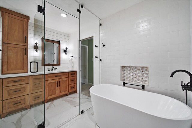 6803 Shady Ln, Richmond, TX 77406 - full bathroom with vanity, a soaking tub, marble tiled floors, and recessed lighting