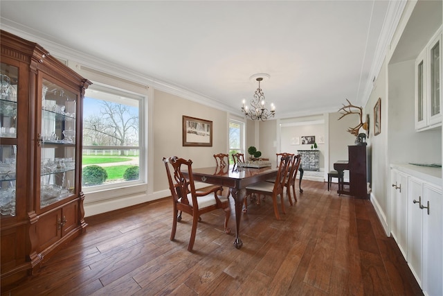 6803 Shady Ln, Richmond, TX 77406 - dining area with a chandelier, dark wood-style floors, ornamental molding, plenty of natural light, and baseboards