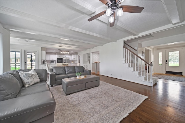 6803 Shady Ln, Richmond, TX 77406 - living area featuring stairway, dark wood finished floors, plenty of natural light, beam ceiling, and ceiling fan