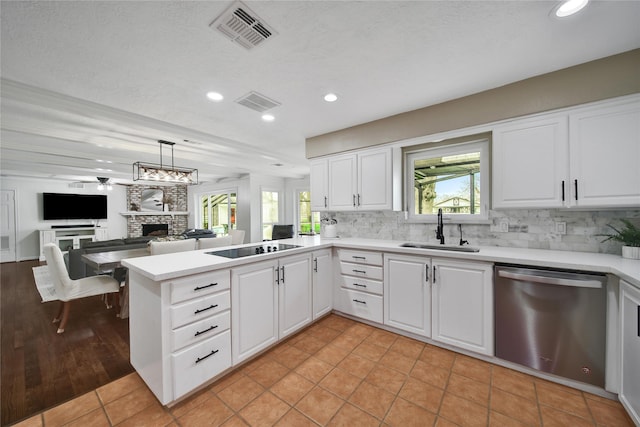 6803 Shady Ln, Richmond, TX 77406 - kitchen with dishwasher, a sink, a stone fireplace, decorative backsplash, and recessed lighting