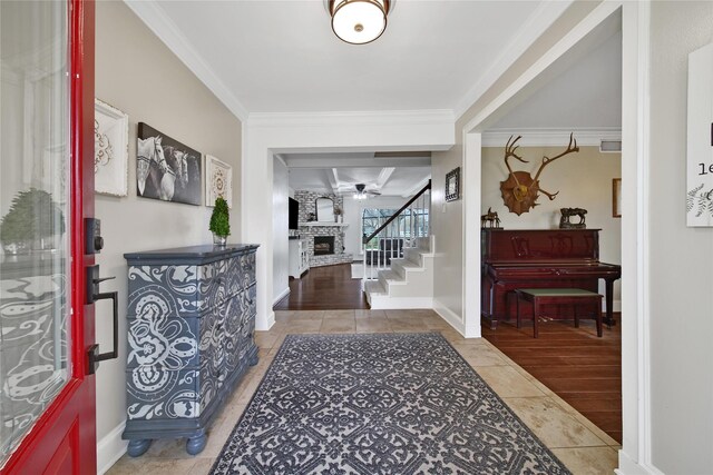 6803 Shady Ln, Richmond, TX 77406 - tiled foyer featuring a fireplace, stairway, crown molding, and baseboards