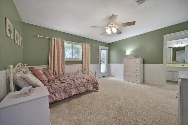 6803 Shady Ln, Richmond, TX 77406 - bedroom featuring a wainscoted wall, carpet, a ceiling fan, and ensuite bath