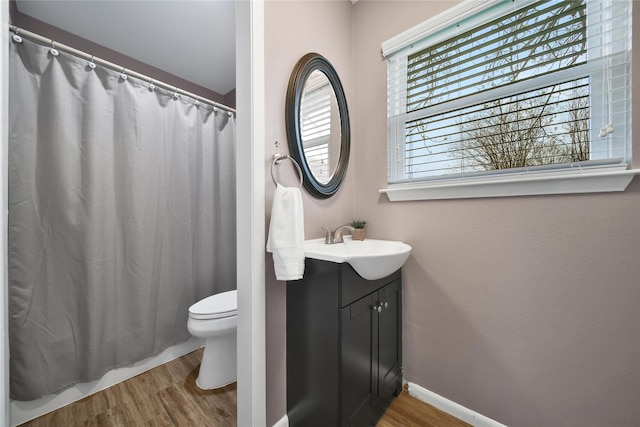 6803 Shady Ln, Richmond, TX 77406 - full bathroom with wood finished floors, vanity, toilet, and a shower with shower curtain
