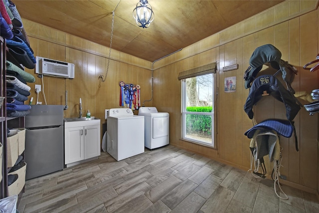6803 Shady Ln, Richmond, TX 77406 - laundry area with cabinet space, separate washer and dryer, wood tiled floors, wooden ceiling, and wooden walls