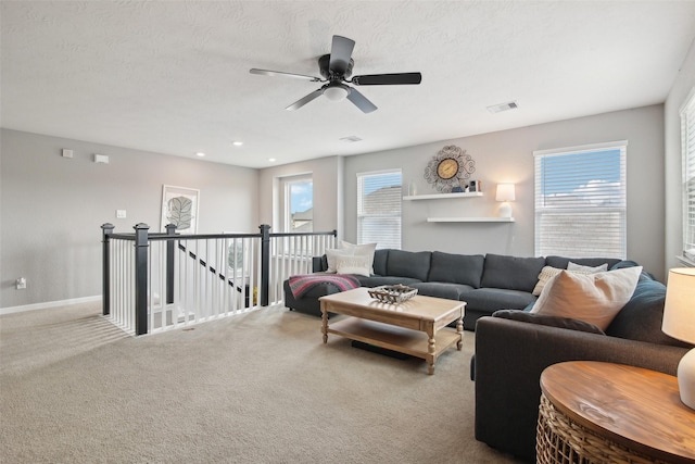 15603 Clearwater Bend Dr, Houston, TX 77044 - living room featuring plenty of natural light, carpet, a ceiling fan, and a textured ceiling