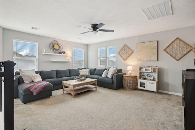 15603 Clearwater Bend Dr, Houston, TX 77044 - living room with healthy amount of natural light, ceiling fan, and light colored carpet