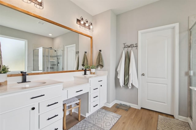 15603 Clearwater Bend Dr, Houston, TX 77044 - full bath featuring double vanity, a stall shower, wood finished floors, and baseboards