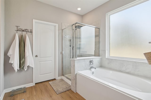 15603 Clearwater Bend Dr, Houston, TX 77044 - bathroom featuring a bath, a shower stall, and wood finished floors