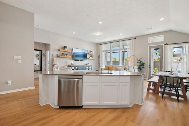 15603 Clearwater Bend Dr, Houston, TX 77044 - kitchen featuring dishwasher, a sink, light wood-style flooring, white cabinetry, and healthy amount of natural light