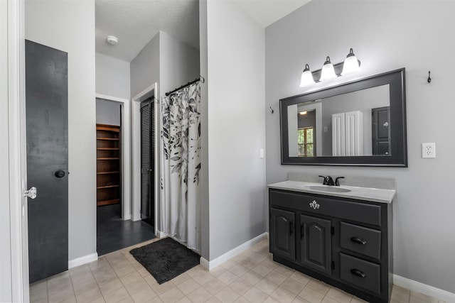 17520 E Williams Rd, Conroe, TX 77303 - full bath featuring vanity, baseboards, and tile patterned floors