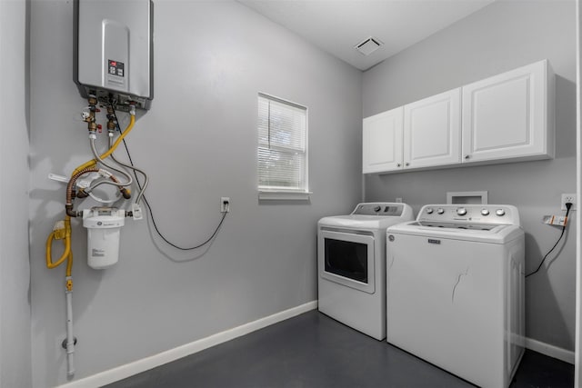 17520 E Williams Rd, Conroe, TX 77303 - laundry room featuring cabinet space, separate washer and dryer, tankless water heater, and baseboards