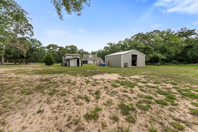 17520 E Williams Rd, Conroe, TX 77303 - view of grassy yard featuring a pole building and an outbuilding