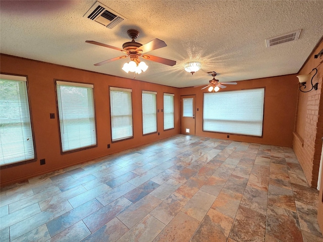11902 25th St, Santa Fe, TX 77510 - unfurnished room featuring a ceiling fan, a textured ceiling, and light stone finish floors